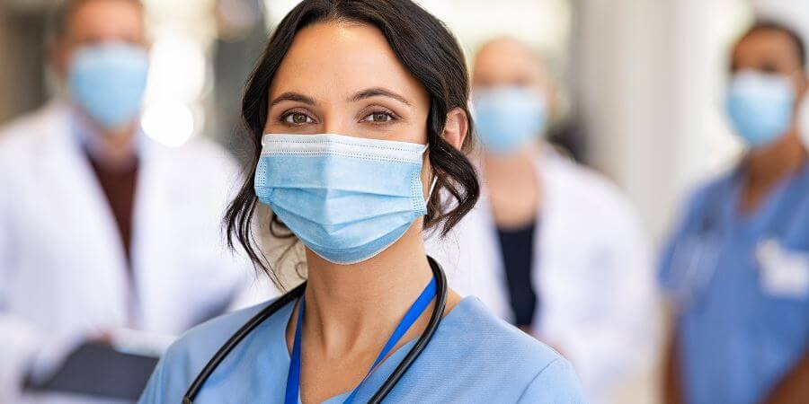 A nurse wearing a face mask.