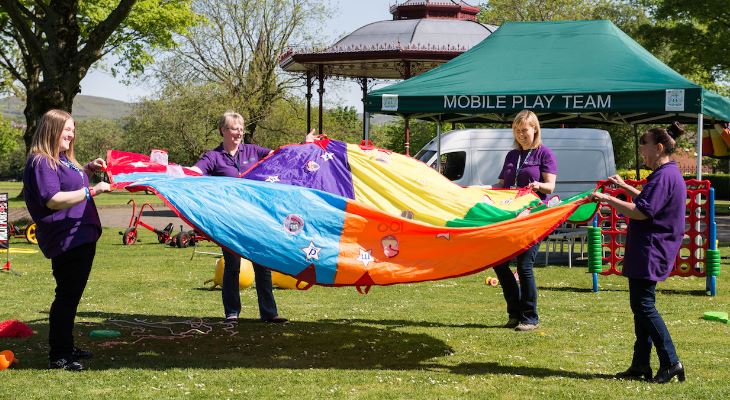 Council staff working together to construct a tent.