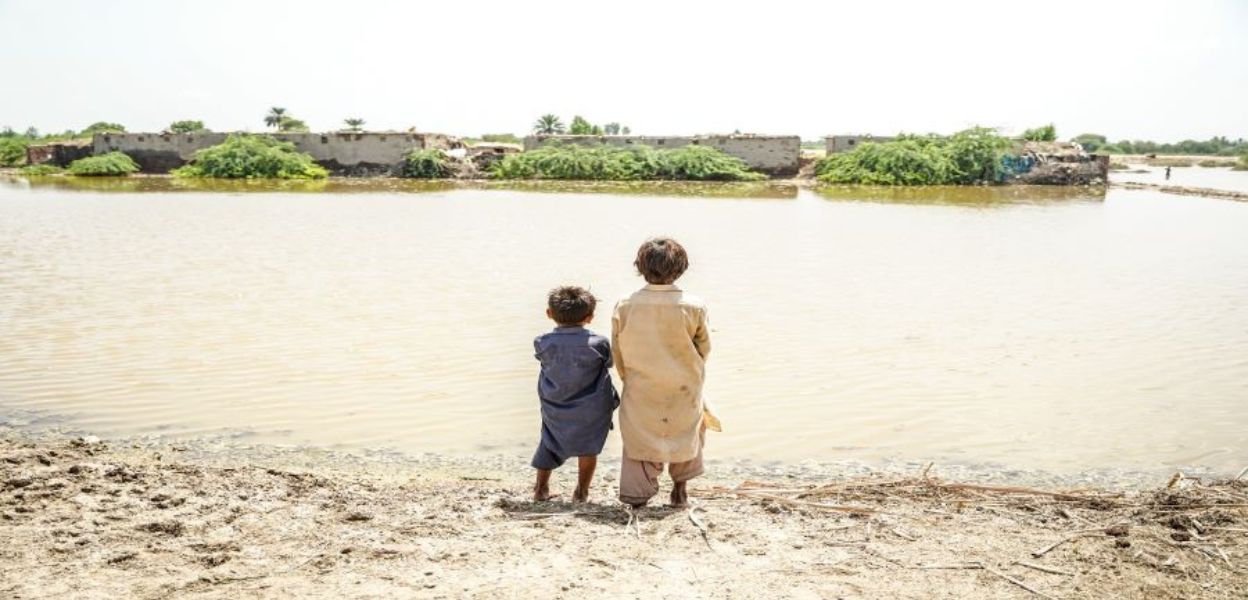 2 children looking out onto the floods in Pakistan.