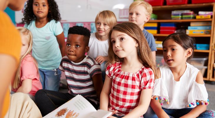 Young children sat listening to a story.