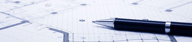 A pen resting on a planning blueprint.