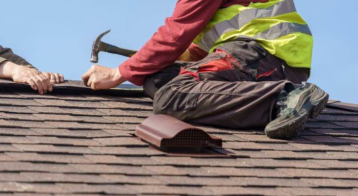 Roofers working on a house roof.