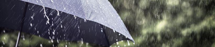 An umbrella held up against heavy rain.