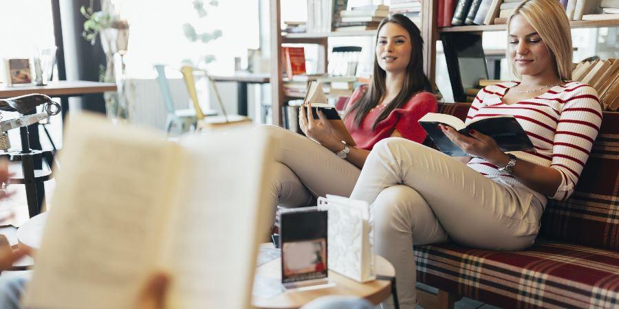 Adults sitting and reading in a relaxed group.