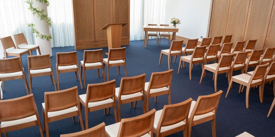 Seats laid out for a wedding in the Red Rose Suite. 