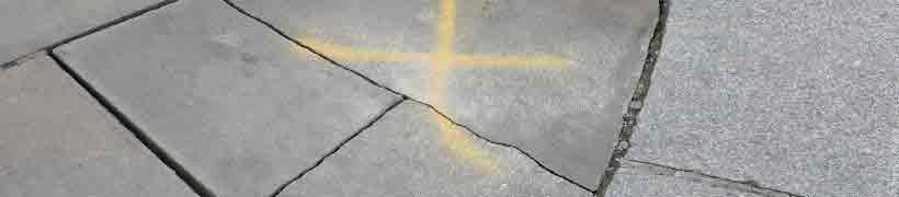 A cracked pavement marked for repair.