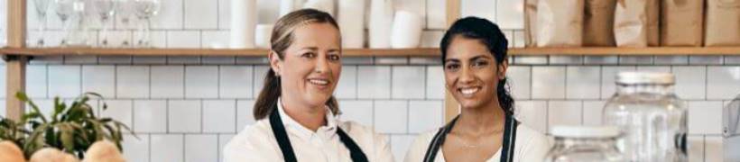 2 smiling businesswomen.