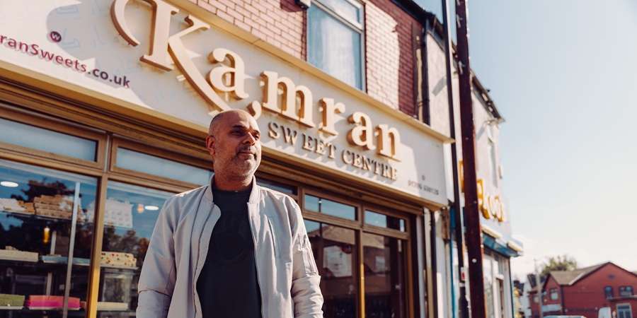 Resident in front of sweet shop.