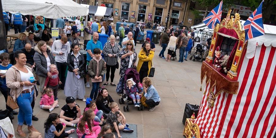 Visitors watching a Punch and Judy Show at Street Eat in 2019.