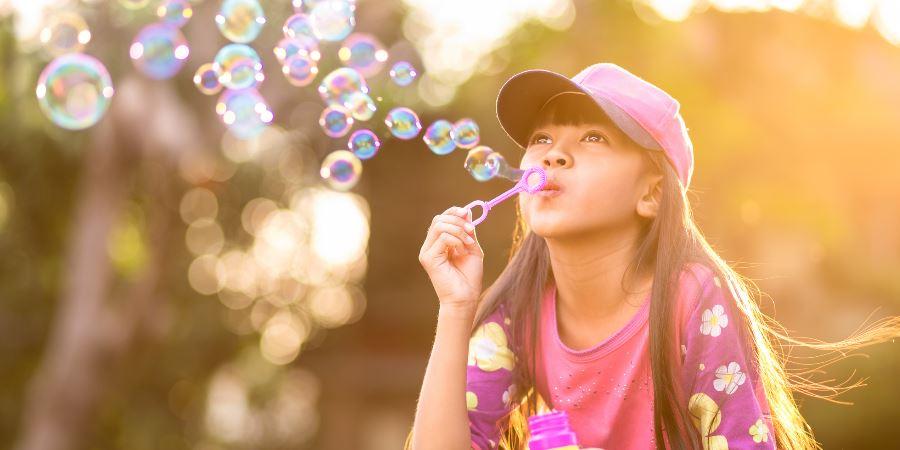 A girl blowing bubbles. 