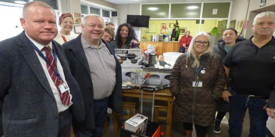 Council leader Neil Emmott with councillor colleagues and volunteers at the launch of the warm spaces scheme, at Bowlee Pavilion.