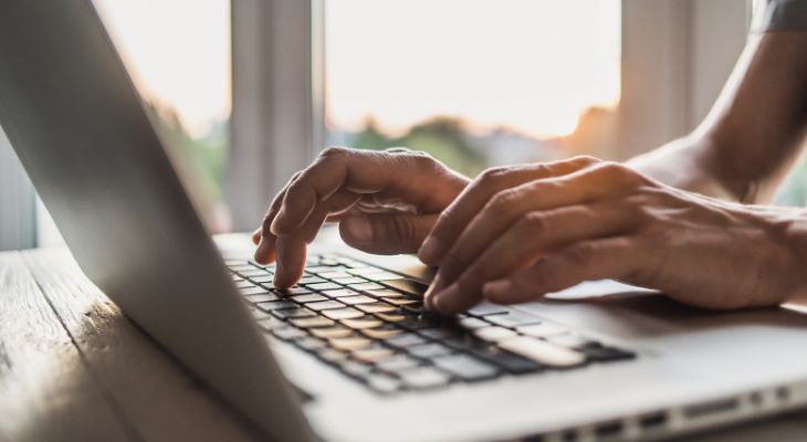 A person typing on their computer.