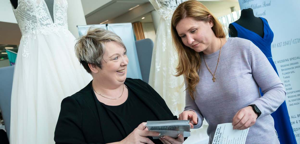 A wedding dress salesperson with a customer.