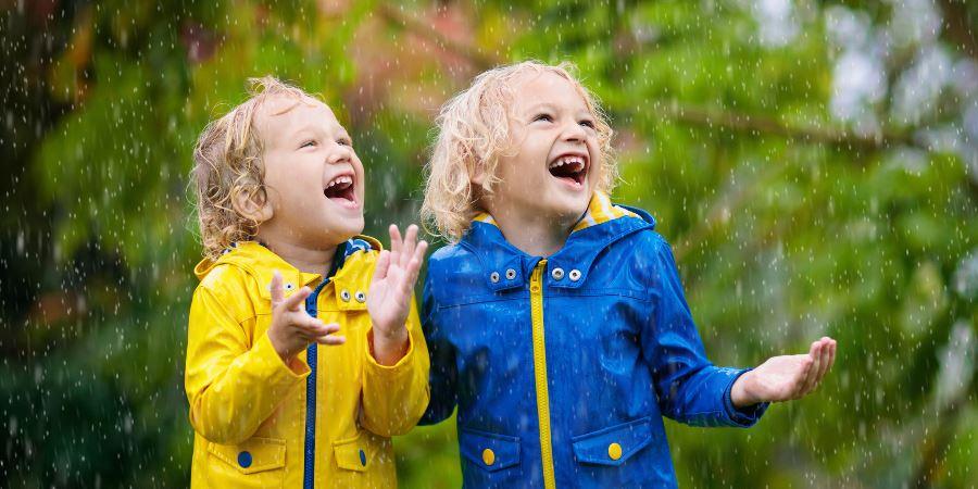 2 young girls laughing in the rain.