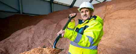 Councillor Shah Wazir holding a shovel of salt.