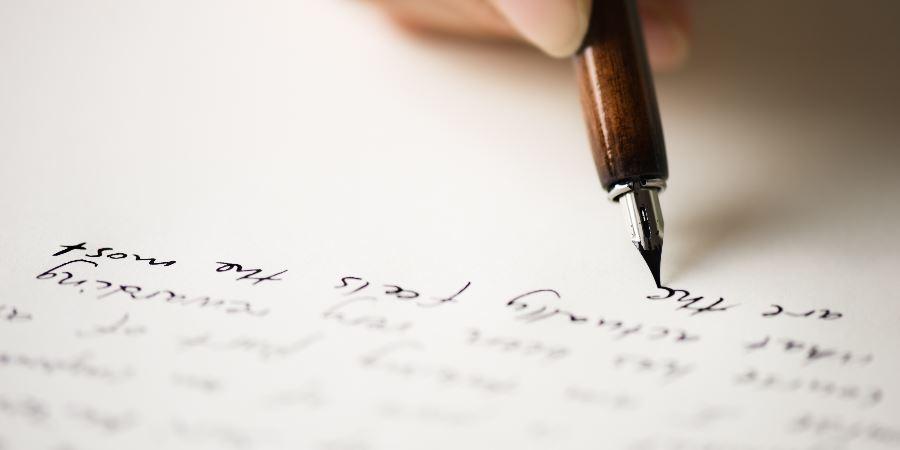 Close-up of a pen writing.